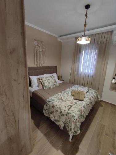 a bedroom with a large bed with a blanket at Evita's House in Doxato