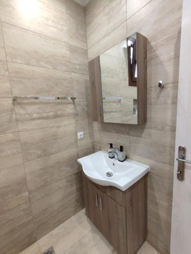 a bathroom with a sink and a mirror at Evita's House in Doxato