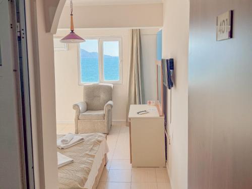 a room with a bed and a chair and a window at Er-öz Hotel & Restaurant in Fethiye