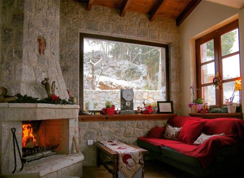 a living room with a couch and a fireplace at Nefeles in Arachova