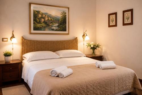 a bedroom with a large bed with towels on it at VillaGrancassa Hotel Relais in San Donato Val di Comino