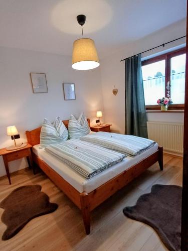 a bedroom with a bed and a large window at Ferienwohnung Schösserhof in Reith bei Kitzbühel