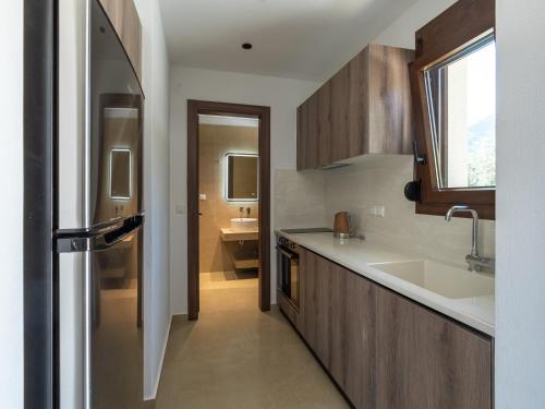 a kitchen with a stainless steel refrigerator and a sink at Elaionas Houses in Skala Potamias