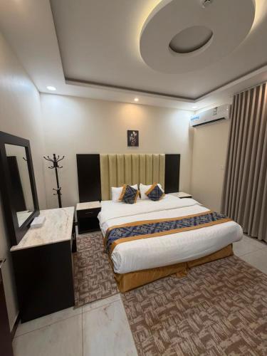 a bedroom with a large bed in a room at Tamyoz Aqama for Serviced Apartments in Hail