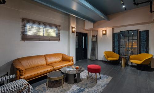 a living room with a couch and a table at Dizengoff Avenue Boutique Hotel - by Echo Hotels in Tel Aviv
