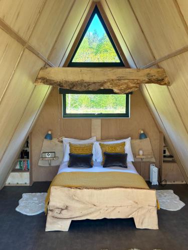 a bed in a small room with a window at Ben Nevis Basecamp in Torlundy