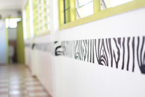 a hallway with zebra stripes on the wall at We Travel Hostel in Moshi