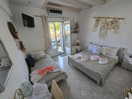 a living room with two beds and a couch at Athina Studios in Chorto