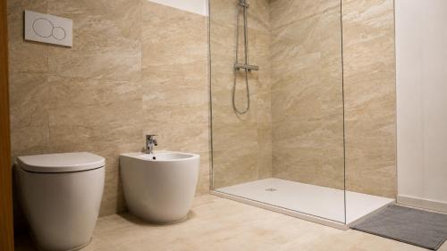 a bathroom with a shower with a toilet and a sink at la Pace camere con bagno nel centro storico di Stia in Stia