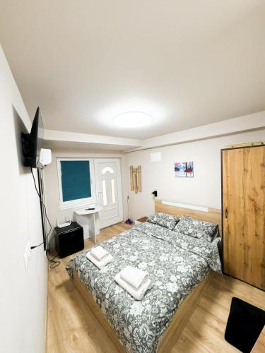 a bedroom with a bed with two towels on it at Little Studio Prespa Best Location in Varna City
