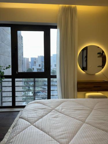 a bedroom with a bed and a mirror and a window at Rent house b8 in Madinaty