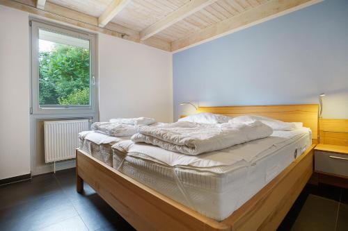 a large bed in a room with a window at Haus E 1 in Röbel