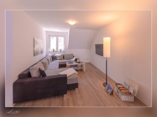 a living room with a couch and a tv at Fewo Müritzfrische 2 in Waren