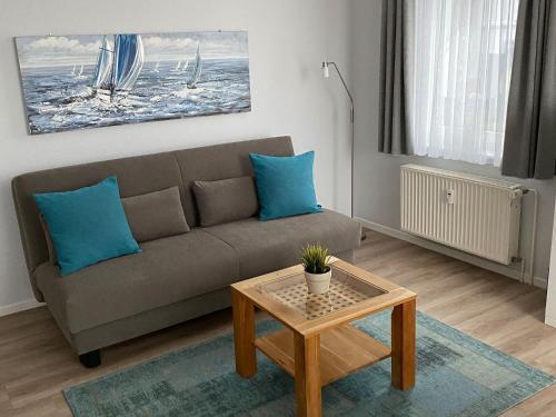a living room with a couch and a table at Am Seeufer 59a Fewo 9 in Waren