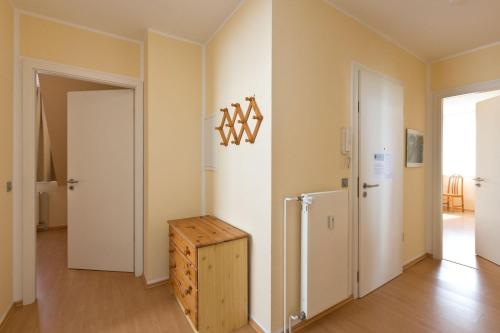 a room with a refrigerator and a wooden box at Am Seeufer 60 Fewo 605 in Waren