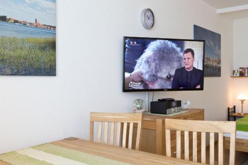 a living room with a flat screen tv on a wall at Am Seeufer 59b Fewo 3 in Waren