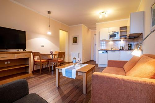 a living room with a couch and a table at Hafendomicil Appartement WH12 - Specht in Waren
