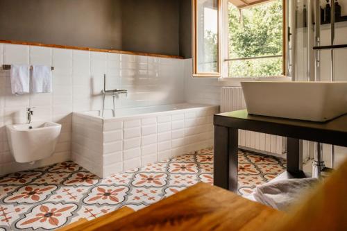a bathroom with a tub and a toilet and a sink at Ca Meison in Cannobio
