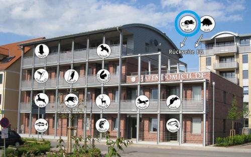 a building with clocks on the side of it at Hafendomicil Appartement WH04 - Igel in Waren