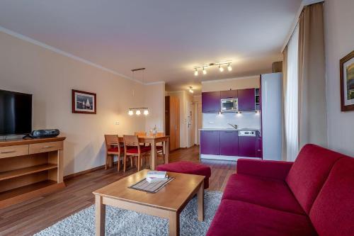 a living room with a red couch and a table at Hafendomicil Appartement WH06 - Hase in Waren