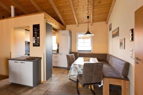 a kitchen and dining room with a table and chairs at Ferienhaus Jabel 28 in Jabel