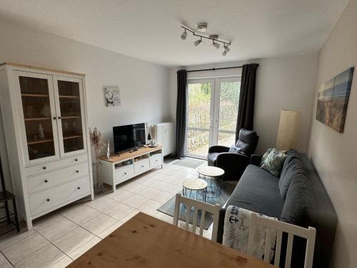 a living room with a couch and a table at UG-Buche in Göhren-Lebbin