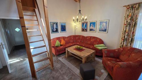 a living room with a red couch and a table at Ferienhaus Jabel 30 in Jabel