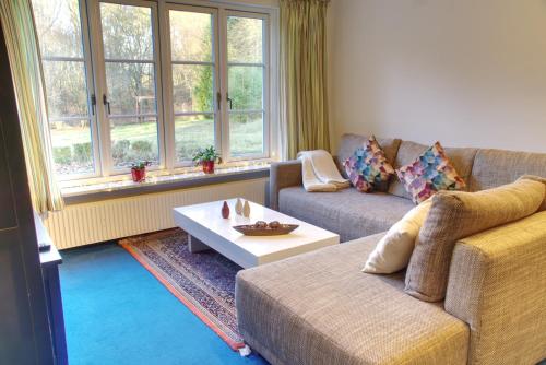 a living room with a couch and a coffee table at Gästehaus Wildblume in Borgdorf-Seedorf