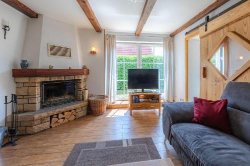a living room with a couch and a fireplace at Ferienhaus Loppin in Jabel