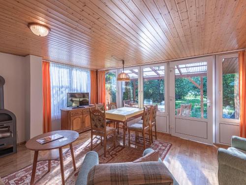 a living room with a table and chairs and a dining room at Luett Huus in Lärz