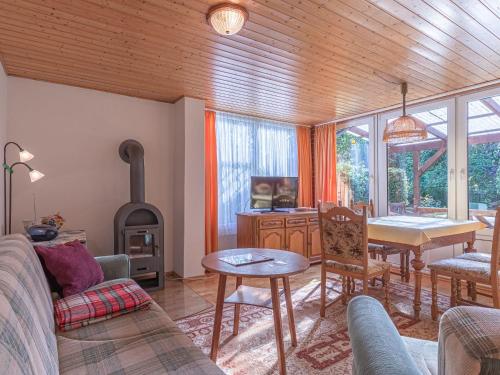 a living room with a table and a wood stove at Luett Huus in Lärz