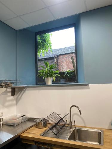 a kitchen with a sink and a window at Ashbourne Gateway Lodge in Ashbourne