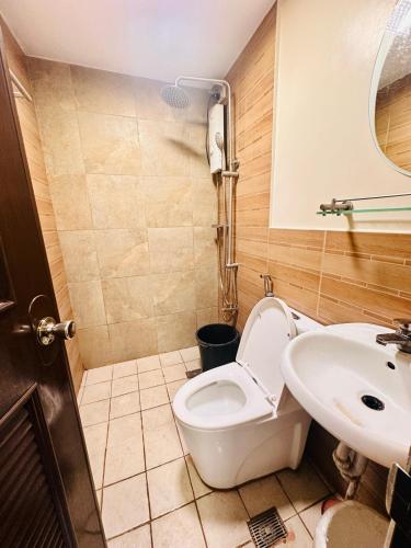 a bathroom with a toilet and a sink at Haku Haven in Baguio
