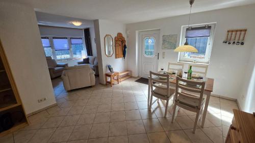 a kitchen and living room with a table and chairs at Ferienhaus Wennmann in Waren