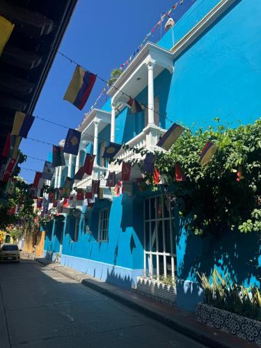 a blue building with flags on the side of a street at Casa 1811 in Cartagena de Indias