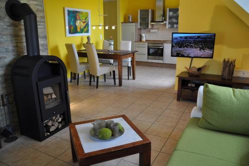 a living room with a wood stove in a room at Fair-Play App 04 DG R in Göhren-Lebbin