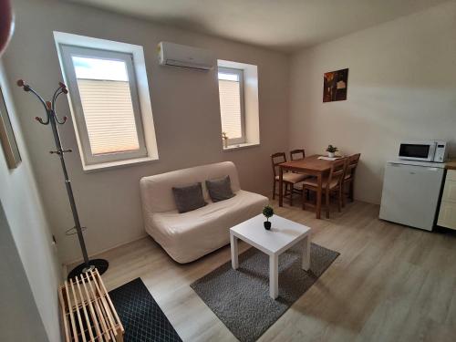 a living room with a couch and a table at Za hrází Poděbrady in Poděbrady