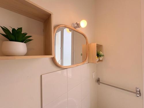 a bathroom with a mirror and a sink at Le Cerf in Montmacq