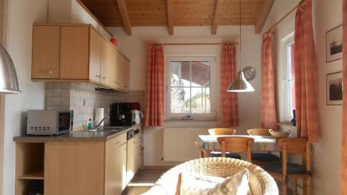 a kitchen with a table and a dining room at Ferienhaus Jabel 24 in Jabel