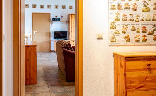 a kitchen and a living room with a couch and a table at Ferienhaus Jabel 25 in Jabel
