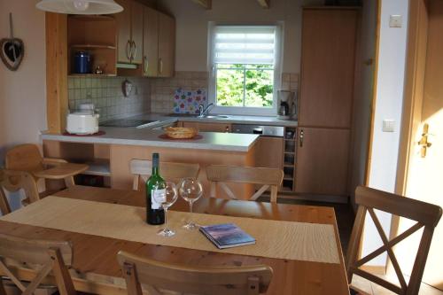 a kitchen with a table with a bottle of wine on it at Ferienhaus Jabel 29 in Jabel