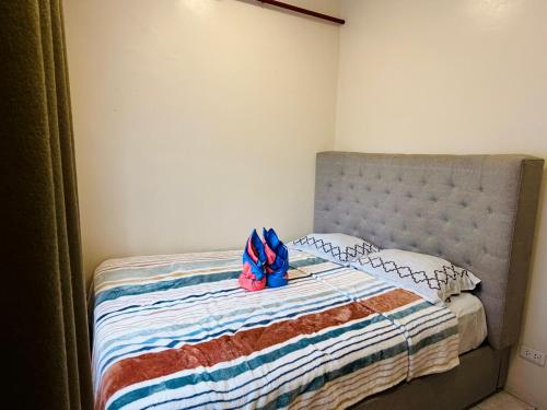 a bed with a blue bow on top of it at Haku Haven in Baguio