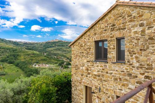 a stone house with a view of a valley at Le Querce Farmhouse in Agropoli