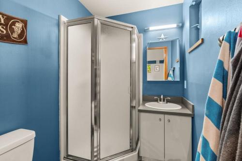a bathroom with a shower and a sink at Dash Point Modern in Tacoma