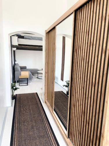 a room with a sliding glass door leading into a living room at ETALON in the heart of Novi Sad in Novi Sad