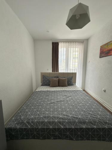 a bedroom with a large bed in a room at Center apartment in Gnjilane