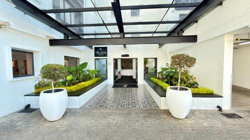 a building with a hallway with plants in it at The Max Hotel Sandton in Johannesburg