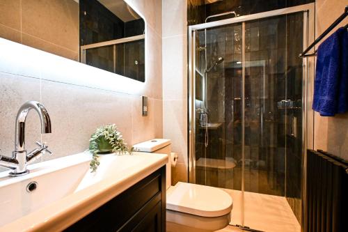 a bathroom with a shower and a sink and a toilet at Radnor Rest in Folkestone