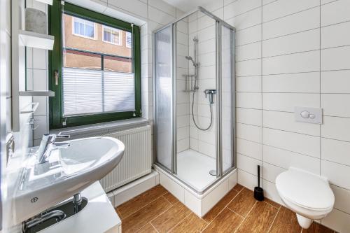 a bathroom with a shower and a sink and a toilet at Am Müritzer Hafen App 1 in Waren
