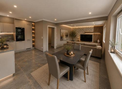 a kitchen and living room with a table and chairs at Waldresidenz Lutz in Bad Lippspringe